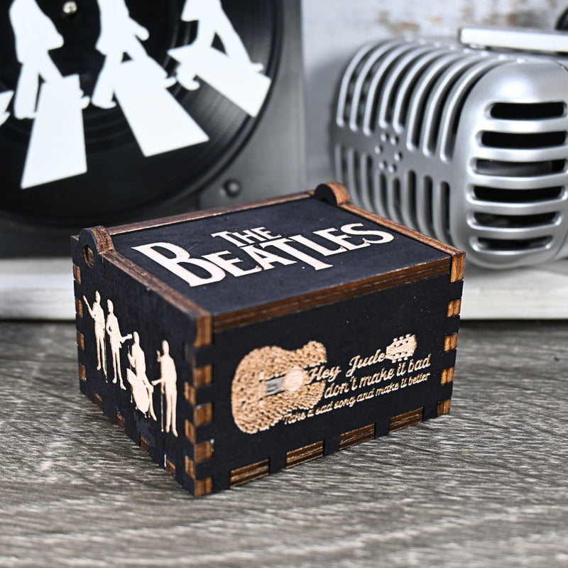 Load image into Gallery viewer, Immerse yourself in the classics of The Beatles as you listen to their legendary songs and lyrics emanating from the finely tuned wooden box. Each music box is a testament to the artistry and attention to detail, making it a perfect gift for anyone!
