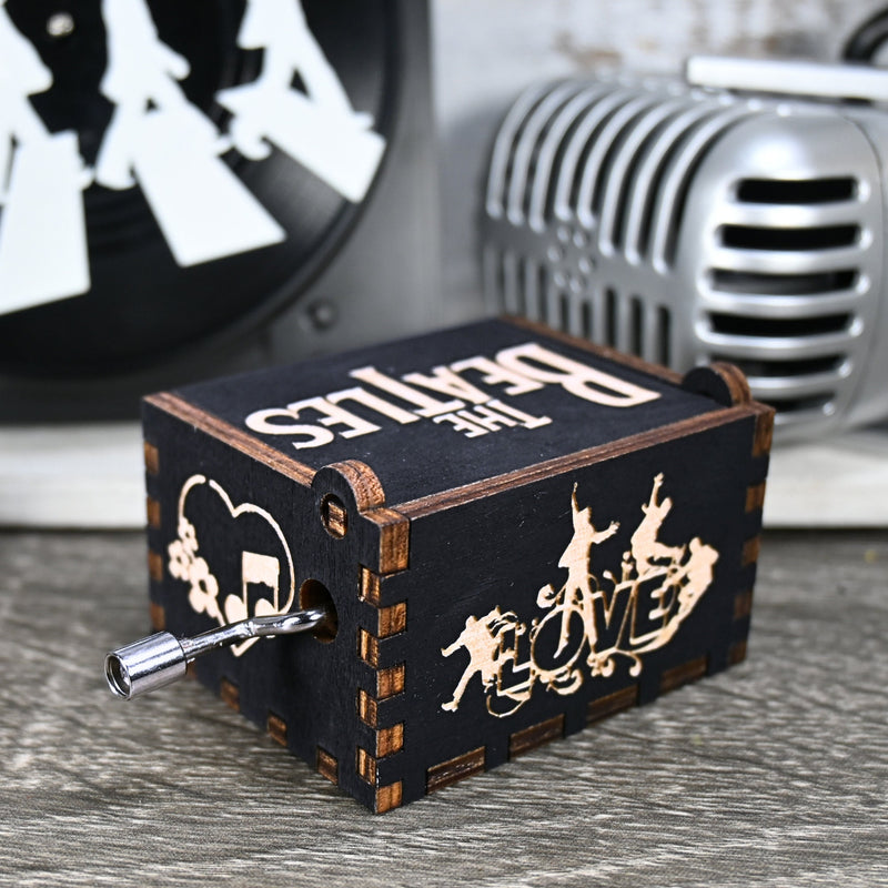 Load image into Gallery viewer, Immerse yourself in the classics of The Beatles as you listen to their legendary songs and lyrics emanating from the finely tuned wooden box. Each music box is a testament to the artistry and attention to detail, making it a perfect gift for anyone!
