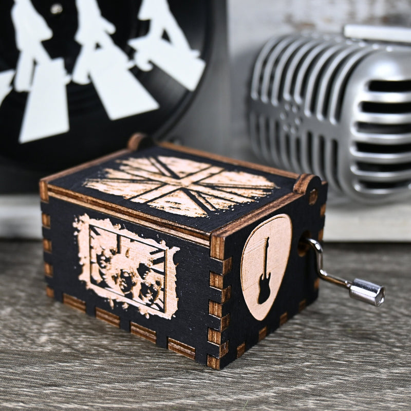 Load image into Gallery viewer, Immerse yourself in the classics of The Beatles as you listen to their legendary songs and lyrics emanating from the finely tuned wooden box. Each music box is a testament to the artistry and attention to detail, making it a perfect gift for anyone!
