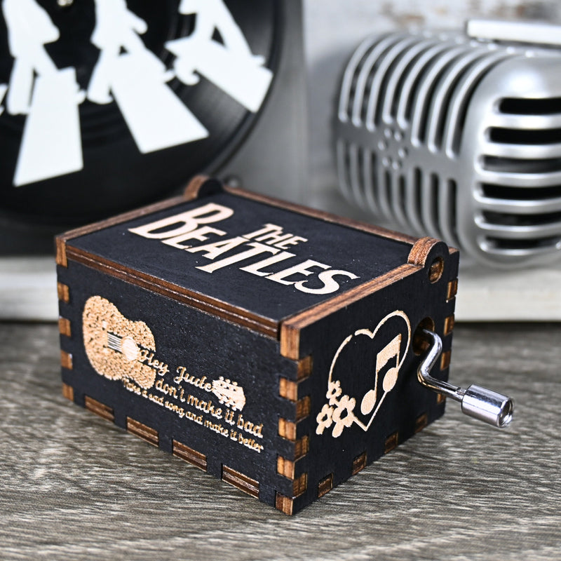 Load image into Gallery viewer, Immerse yourself in the classics of The Beatles as you listen to their legendary songs and lyrics emanating from the finely tuned wooden box. Each music box is a testament to the artistry and attention to detail, making it a perfect gift for anyone!
