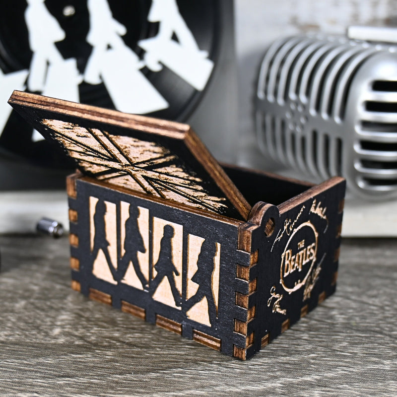 Load image into Gallery viewer, Immerse yourself in the classics of The Beatles as you listen to their legendary songs and lyrics emanating from the finely tuned wooden box. Each music box is a testament to the artistry and attention to detail, making it a perfect gift for anyone!
