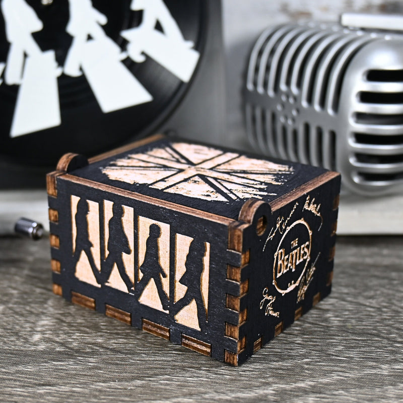 Load image into Gallery viewer, Immerse yourself in the classics of The Beatles as you listen to their legendary songs and lyrics emanating from the finely tuned wooden box. Each music box is a testament to the artistry and attention to detail, making it a perfect gift for anyone!
