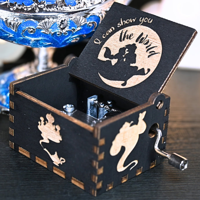 The Aladdin music box features intricate designs that capture the essence of the classic tale, including Aladdin and Princess Jasmine flying on the magic carpet. Its stunning design and enchanting melody make it the perfect gift for any occasion.