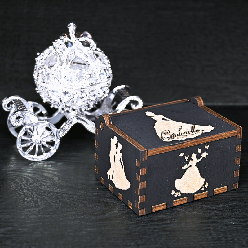 Load image into Gallery viewer, Experience the enchanting world of Cinderella with a music box that captures the tale in all its glory. As you turn the key, the sweet melody fills the air. This music box is a delightful treat for yourself or a loved one.
