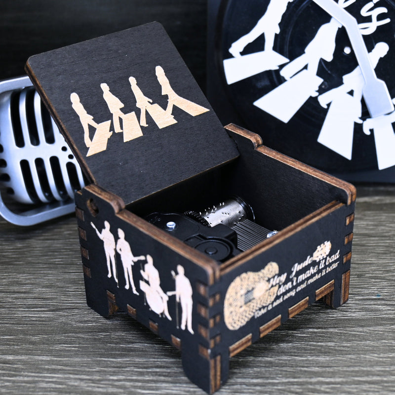 Load image into Gallery viewer, Immerse yourself in the classics of The Beatles as you listen to their legendary songs and lyrics emanating from the finely tuned wooden box. Each music box is a testament to the artistry and attention to detail, making it a perfect gift for anyone!
