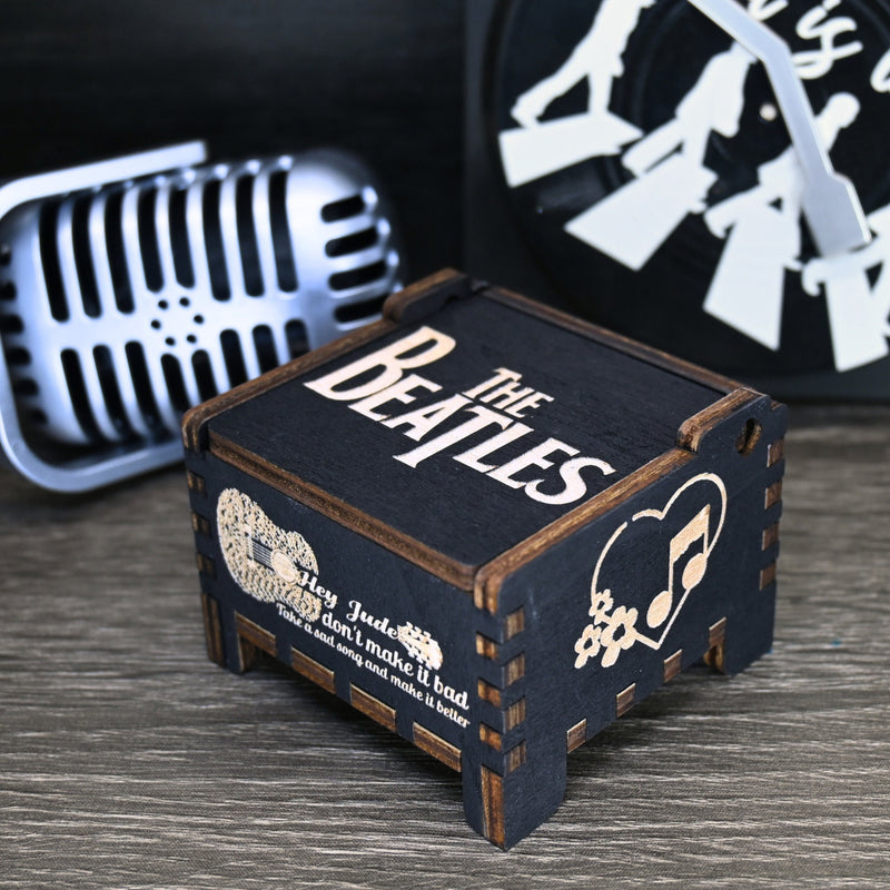 Load image into Gallery viewer, Immerse yourself in the classics of The Beatles as you listen to their legendary songs and lyrics emanating from the finely tuned wooden box. Each music box is a testament to the artistry and attention to detail, making it a perfect gift for anyone!
