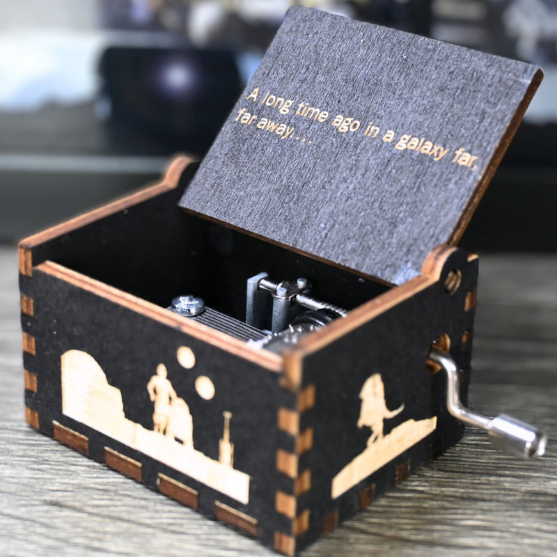 Load image into Gallery viewer, Are you a devoted follower of the Star Wars franchise? If so, you&#39;ll be thrilled to experience the excitement and adventure of your favorite movies in a whole new dimension with this exquisite music box. The box is masterfully handcrafted.
