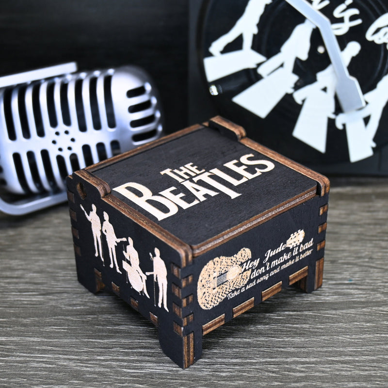 Load image into Gallery viewer, Immerse yourself in the classics of The Beatles as you listen to their legendary songs and lyrics emanating from the finely tuned wooden box. Each music box is a testament to the artistry and attention to detail, making it a perfect gift for anyone!
