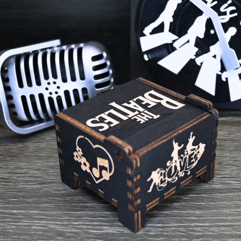 Load image into Gallery viewer, Immerse yourself in the classics of The Beatles as you listen to their legendary songs and lyrics emanating from the finely tuned wooden box. Each music box is a testament to the artistry and attention to detail, making it a perfect gift for anyone!
