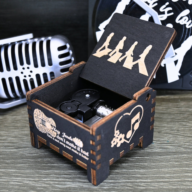 Load image into Gallery viewer, Immerse yourself in the classics of The Beatles as you listen to their legendary songs and lyrics emanating from the finely tuned wooden box. Each music box is a testament to the artistry and attention to detail, making it a perfect gift for anyone!
