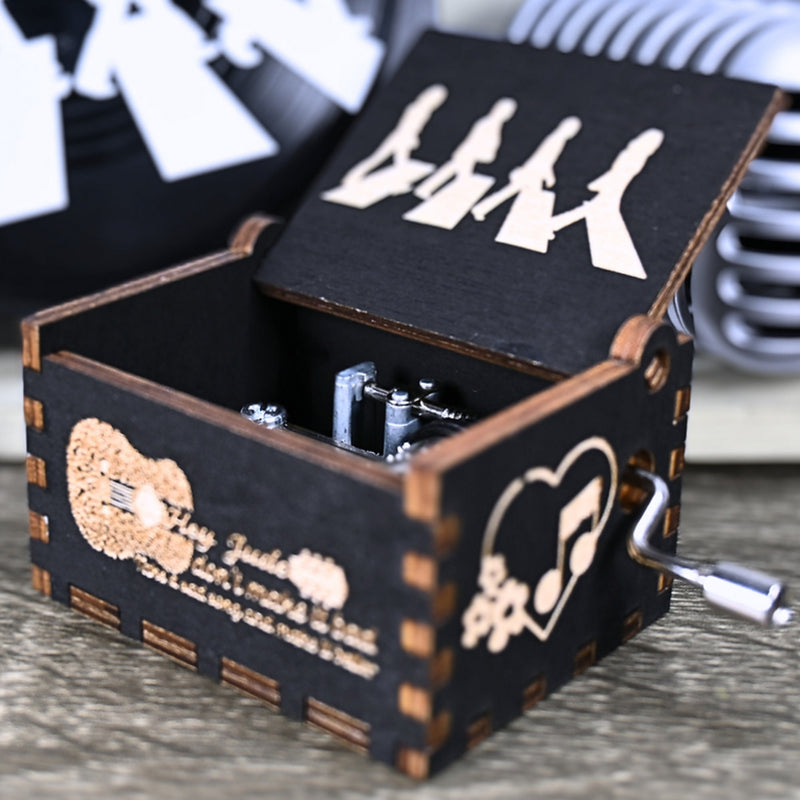 Load image into Gallery viewer, Immerse yourself in the classics of The Beatles as you listen to their legendary songs and lyrics emanating from the finely tuned wooden box. Each music box is a testament to the artistry and attention to detail, making it a perfect gift for anyone!
